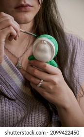 Small Woman Holding Small Brush To Paint Green Figure With Pearl Necklace And Ring Long Brown Hair Latina