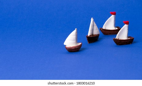 small wooden boat model on blue background