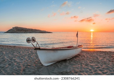 Small wooden boat on pier sandy beach. Mediterranean sea. old boats on the sandy shore. small wooden fishing boats on the sand near the sea. Boat on the beach at sunset time in jijel Algeria Africa. - Powered by Shutterstock