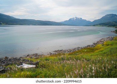 A Small Wooden Boat In The Shore Of A Lake In Lofoten Islands, Norway