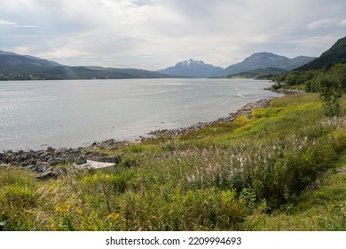 A Small Wooden Boat In The Shore Of A Lake In Lofoten Islands, Norway