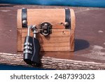 Small wooden box with a combination lock. Escape room, decipher, escape, outdoor escape room.