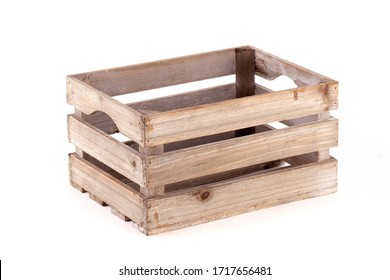 Small wooden box crate used for fruit or vegetables on a farm or shop. Slatted pine crate isolated on a white background