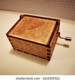 Small Wooden Box Which Plays Music On White Paper Background 