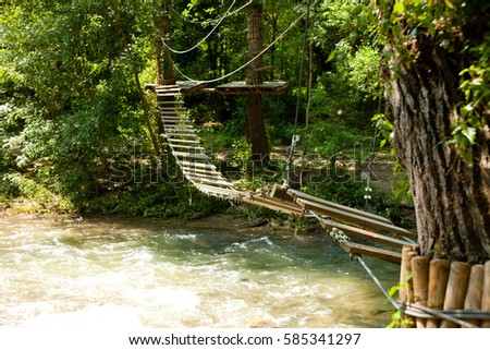 Small wooden bridge over a river  in the forest