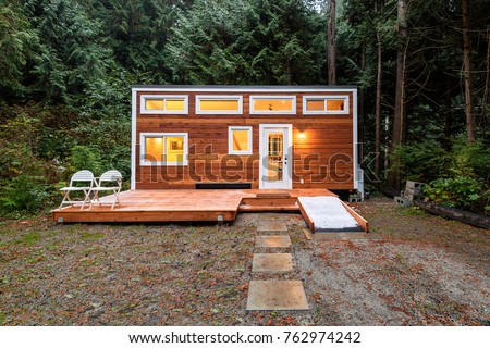 Small wooden cabin house in the evening. Exterior design.