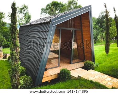 Small wooden cabin house outdoors. Exterior design.