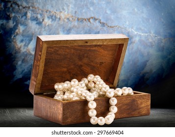 Small Wooden Chest With White Pearl Necklace