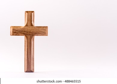 Small Wooden Christian Cross On A White Background