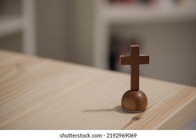 Small Wooden Cross On A Desk