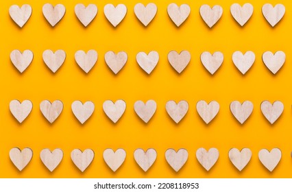 Small wooden hearts on a yellow background. A creative idea. Valentine day greeting card. - Powered by Shutterstock