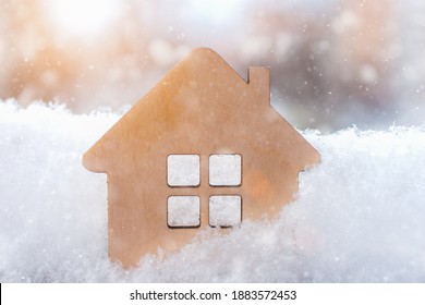 Small Wooden House Close-up In The Winter Snow. Idea - Christmas Sales, Winter Discounts On Real Estate, Buying Your Own Home, Mortgage, Affordable Housing. Horizontal Photo.