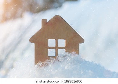 small wooden house close-up in winter, on a background of snow. Idea - winter discounts for home purchases, 2021 sales, New Year discounts. affordable housing, mortgage. Horizontal photo