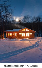 A Small Wooden House In A Snowy Forest