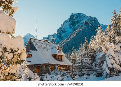 A Small Wooden House In A Snowy Mountains