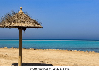 A small wooden hut on a tropical beach with the Red Sea view in Al Saif beach, Jeddah, Saudi Arabia - Powered by Shutterstock