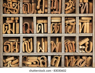 small wooden letters of the thai alphabet sorted by character in compartments in carpenters shop bangkok thailand