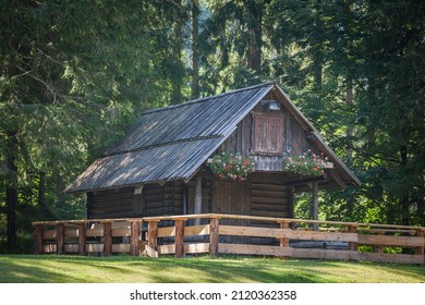 Small wooden shed, a slovenian chalet made of wood, in the middle of a small mountain glade in the middle of the Julian alps, in the Julijske Alpe of Slovenia.