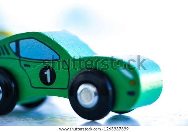 small wooden toy car\
number one or 1