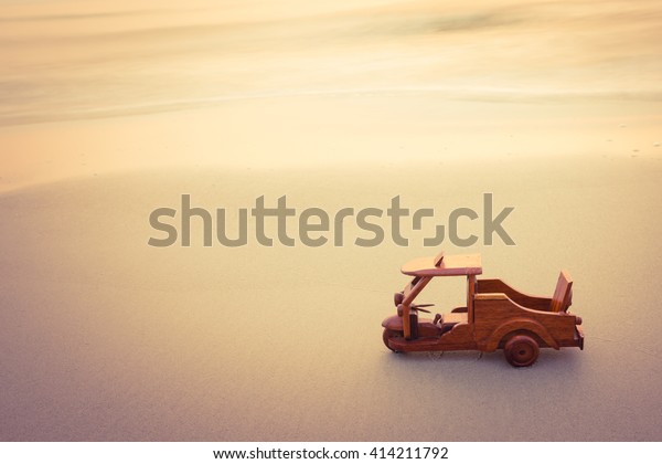 Small wooden
toy car (Tuk Tuk Thailand) on
beach