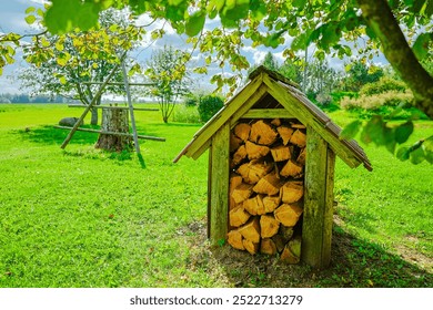 small woodpile shelter in grass field open air summer time vintage - Powered by Shutterstock