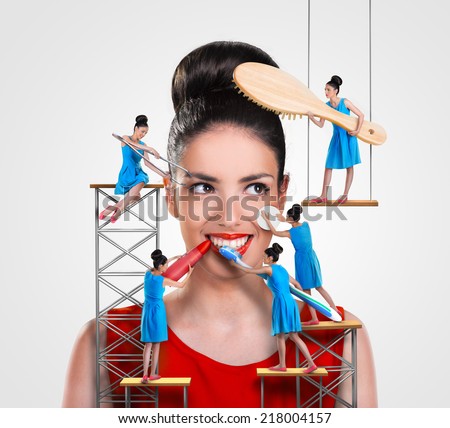 Small workers working on a beautiful woman