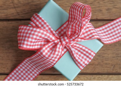 Small Wrapped Gift With A Large Gingham Ribbon Bow