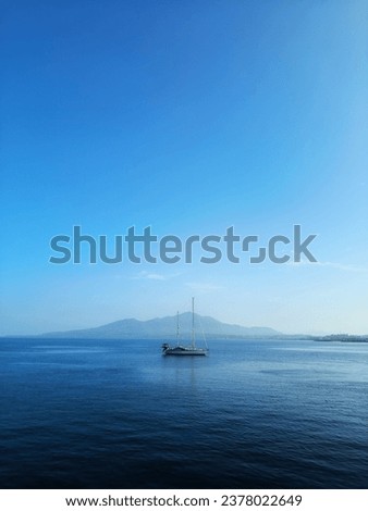 A small yacht is located on the coast of Manado City