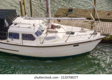 Small Yacht Moored To Pontoon Jetty. Leisure Sail Boat On River Mooring.  