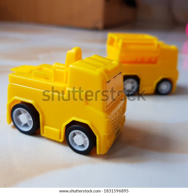 small yellow toy cars on the\
floor