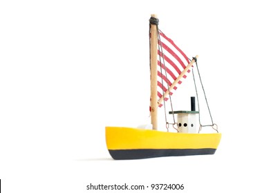 Small Yellow Toy Sailing Boat On White Background