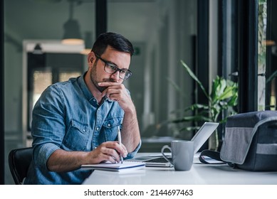 Smart adult man, thinking about how to improve his company project. - Shutterstock ID 2144697463