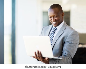 Smart African Business Man Using Laptop In Office