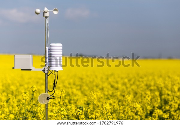 Smart agriculture and smart farm technology\
concept. Weatherstation with anemometer, a meteorological\
instrument used to measure the wind speed and thermometer,\
measuring of rainfalll and leaf\
wetness