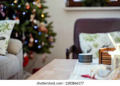 Smart Ai Speaker With Man Cooking In The Background. Smart Home Concept During Christmas Holiday Winter Time