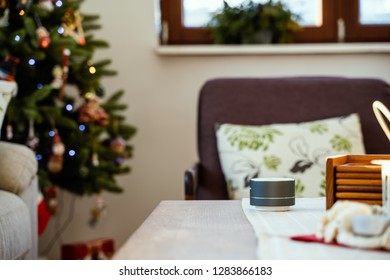 Smart Ai Speaker With Man Cooking In The Background. Smart Home Concept During Christmas Holiday Winter Time