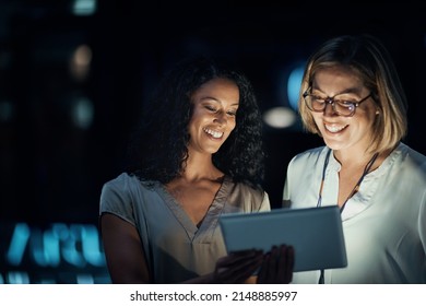 Smart apps made their night productive. Shot of two colleagues using a digital tablet together during a late night at work. - Powered by Shutterstock