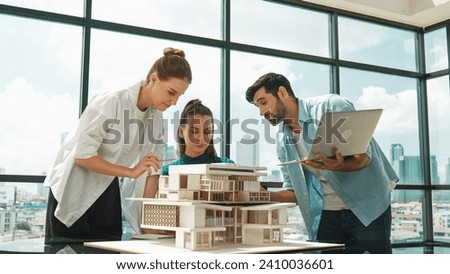 Smart architect team discussion about house design while handsome male worker present idea by using laptop. Group of professional engineer sharing, brainstorming design. Business design. Tracery