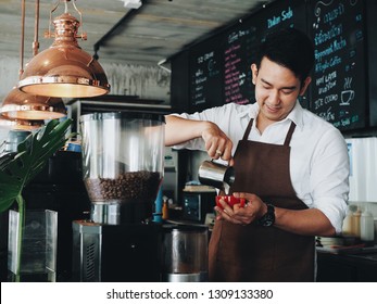 Smart Asian Barista Making A Hot Coffee Cup In His Coffee Shop.