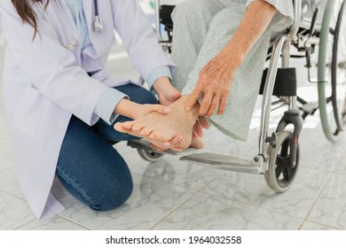 smart asian doctor holding leg of old stroke patient in hospital, elderly rehabilitation clinic, they training to rehab muscle, chronic ankle pain