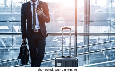 Smart Asian man using smartphone connection concept  At the international airport. Soft focus technique