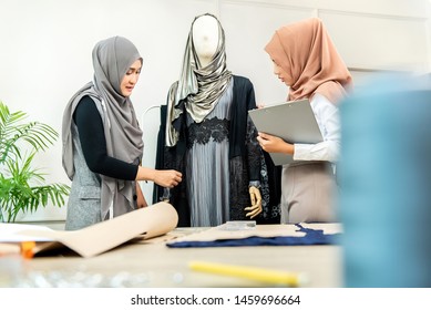 Smart Asian Muslim Dressmakers Working On Their New Collection At Their Fashion Shop