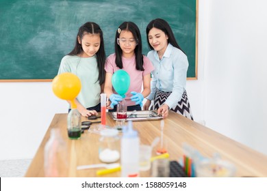 smart asian students learning to experimentation with female teacher in classroom, they explaining about red chemical solution in glass bottle, science education activity - Powered by Shutterstock