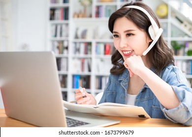 Smart Asian Young Girl Student Learning Language During Internet Online Courses And She Search Information Via Laptop Computer At Home