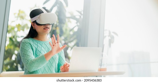 Smart Attractive Asian Female Business Owner Weared Virtual Reality Glasses Enjoys Casual Metaverse Meeting With Concentrate At Cafe Restaurant,asian Female  Using Oculus Rift Headset In Cafe