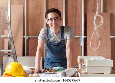smart attractive handy glasses asian male craftman or interior designer focus wood working at site constrution home interior design house renovation and improvement concept