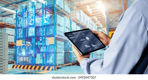 Smart Augmented Reality,AR warehouse management system.Worker hands holding tablet on blurred warehouse as background