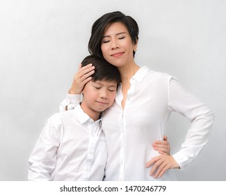 A Smart Beautiful Asian Mom Gently Hold Her Beloved Preteen Son Close To Her Heart With Love. Mother And Child Bonding, Love Expression, Mother's Day, Love Mom, Parenting Teen, Single Mom Concept.