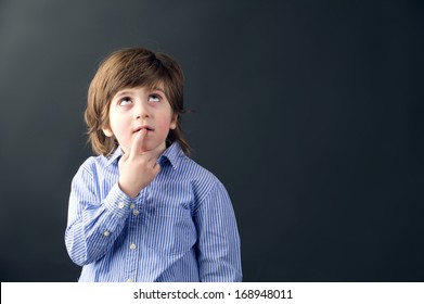 Smart Beautiful Kid Thinking Against A Black Background