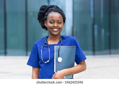Smart Black Girl Medical Student, Happy Young African American Woman Doctor, Nurse In Blue Uniform, Stethoscope, Smiling Afro Female At University, College, Hospital, Clinic. Copy Space